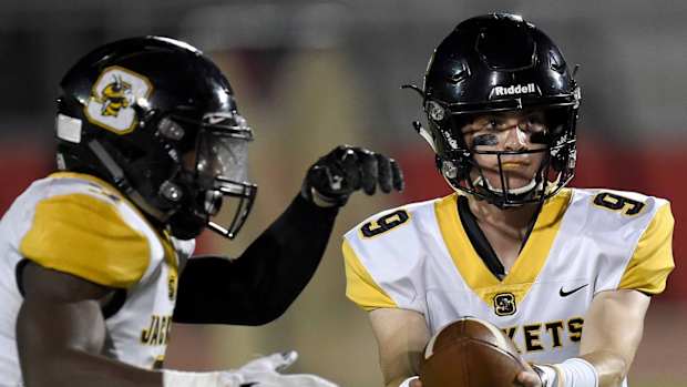 Starkville quarterback Luke Altmyer (9) hands off to Rodriques Clark on Friday, November 2, 2018, at Clinton High School in Clinton, Miss.11 02 Clinton Starkville 004